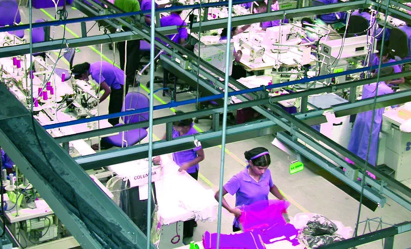 Garment factory floor in Noida with rows of sewing stations where RFID sensors are deployed