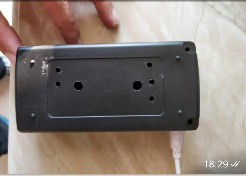 Black plastic case with holes cut for a Raspberry Pi camera module