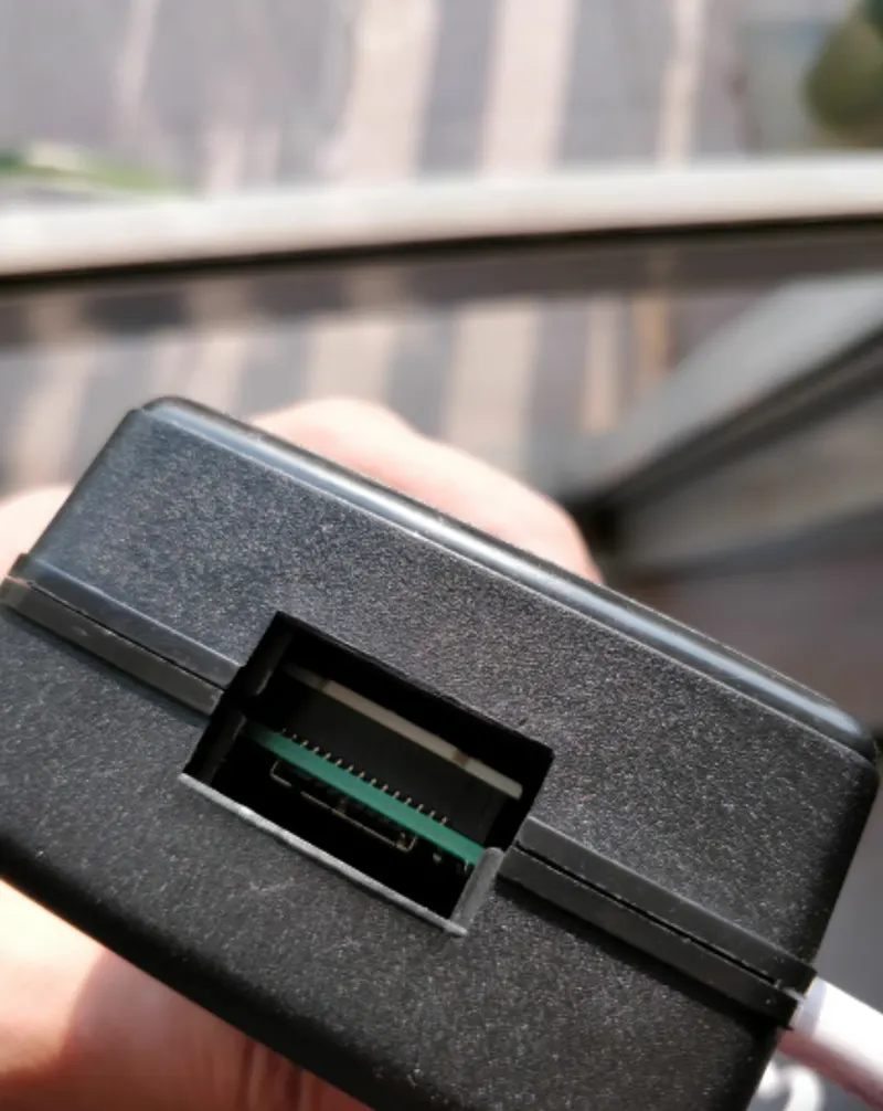 Raspberry Pi board sitting inside an empty black laptop-charger case
